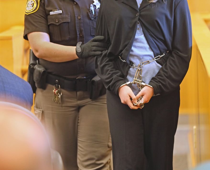 One of two girls, suspects in the Slenderman stabbing case, is escorted into court in Milwaukee on Friday, March 13, 2015. On Friday, a judge decided to try the two 12-year-olds as adults. The two girls told detectives the attack was an attempt to please Slenderman, a fictional character they found on a horror website. If convicted, they could be sentenced to 65 years. (AP Photo/Milwaukee Journal-Sentinel, Michael Sears)
