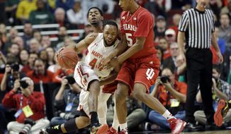 Maryland&#x27;s Dez Wells (44), left, is defended by Indiana&#x27;s Troy Williams (5) in the first half of an NCAA college basketball game in the quarterfinals of the Big Ten Conference tournament in Chicago, Friday, March 13, 2015. (AP Photo/Nam Y. Huh)