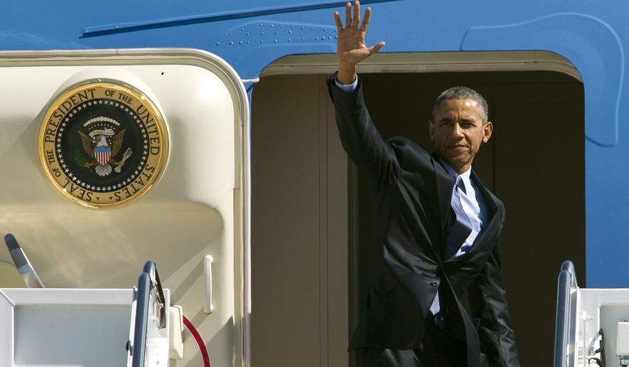 President Obama waves from Air Force One before departing Andrews Air Force Base, Md., en route to Los Angeles on March 12, 2015. (Associated Press) **FILE**