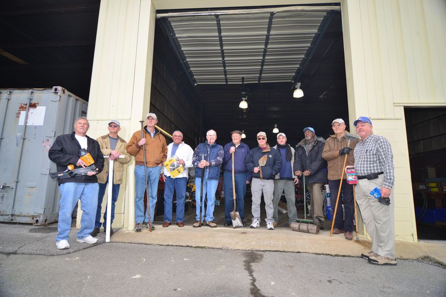 A group of men know as the Kingsport Regulars pose outside there storage building in Kingsport, Tenn, March 20, 2013. The get together and help build houses for low-income families L to R: Jim Boushley, Doyle Alley, John Peters, Geoff Dougal, Charles Barrett, Gordon Travis, Dick Orr, J.J., John Harrison, Chuck Smith and Al Miller . (AP Photo/Kingsport Times News, David Grace)