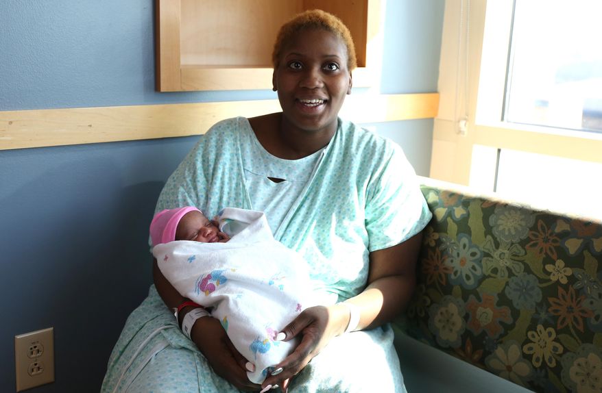 Brittany Young, 24, of Des Moines, Iowa, went into labor and had delivered her baby, Miracle, in the shower of her apartment. Young knew she was pregnant, but thought she was earlier along than she was on Wednesday, March 11, 2015, Des Moines, Iowa. (AP Photo/The Des Moines Register, Bryon Houlgrave)