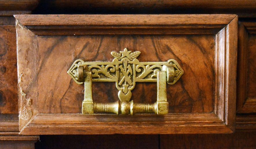 In this March 8, 2015 photo, the handles on the drawers of the Arthur I. Boreman Sideboard is displayed in Reedy, W.Va. It stands over eight feet tall and weighs more than 600 pounds and comes apart in three pieces and is held together by weight. The sideboard was the property of Arthur I. Boreman, when he was the first governor of West Virginia and was crafted by Frederick Schmeichel of Wheeling. (AP Photo//Parkersburg News & Sentinel, Jeff Baughan)