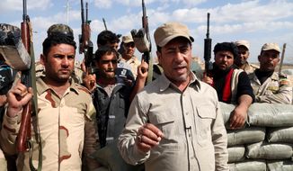 Hakim al-Zamili, a parliament member and head of Security and Defense Committee, right, visits the front line during a battle against Islamic State militants in Tikrit, 130 kilometers (80 miles) north of Baghdad, Iraq, Monday, March 16, 2015. The offensive to retake Saddam Hussein&#39;s hometown of Tikrit began March 2. The city is one of the largest held by the Islamic State militants on the road connected Baghdad and Mosul. Iraqi Interior Minister Mohammed Salem al-Ghabban said Monday that the campaign had halted temporarily to allow civilians in the city to evacuate and to enable troops to clear roadside bombs planted by the extremists. (AP Photo/Khalid Mohammed)