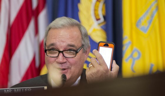 House Veterans&#39; Affairs Committee Chairman Rep. Jeff Miller, R-Fla., conveys a message he reads from his mobile phone to witness, Veterans Affairs Secretary Robert McDonald, on Capitol Hill in Washington on Feb. 11, 2015. Miller on March 16, accused the inspector general and other officials at the Department of Veterans Affairs of withholding reports from his panel, despite pledges to be transparent. (Associated Press) **FILE**