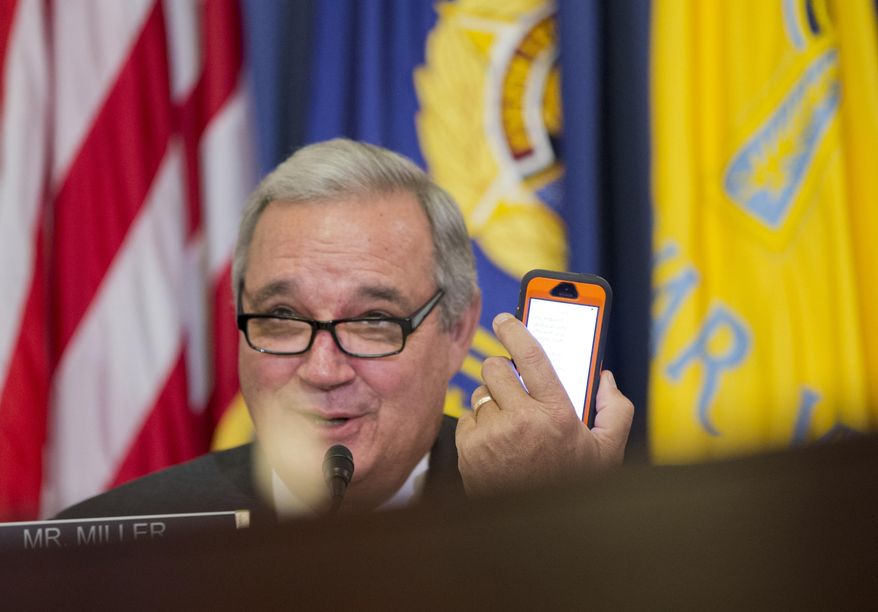 House Veterans&#39; Affairs Committee Chairman Rep. Jeff Miller, R-Fla., conveys a message he reads from his mobile phone to witness, Veterans Affairs Secretary Robert McDonald, on Capitol Hill in Washington on Feb. 11, 2015. Miller on March 16, accused the inspector general and other officials at the Department of Veterans Affairs of withholding reports from his panel, despite pledges to be transparent. (Associated Press) **FILE**