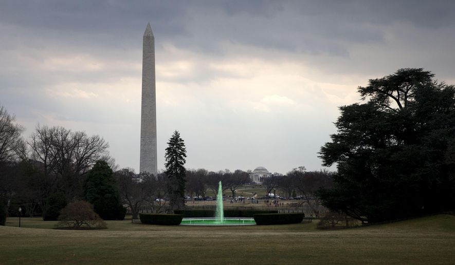 With the Washington Monument and Jefferson Memorial in the background, the fountain on the South Lawn of the White House in Washington, is dyed green for St. Patrick's Day, Tuesday, March 17, 2015, prior to President Barack Obama's motorcade taking the president to Capitol Hill for a "Friends of Ireland" luncheon. (AP Photo/Jacquelyn Martin)
