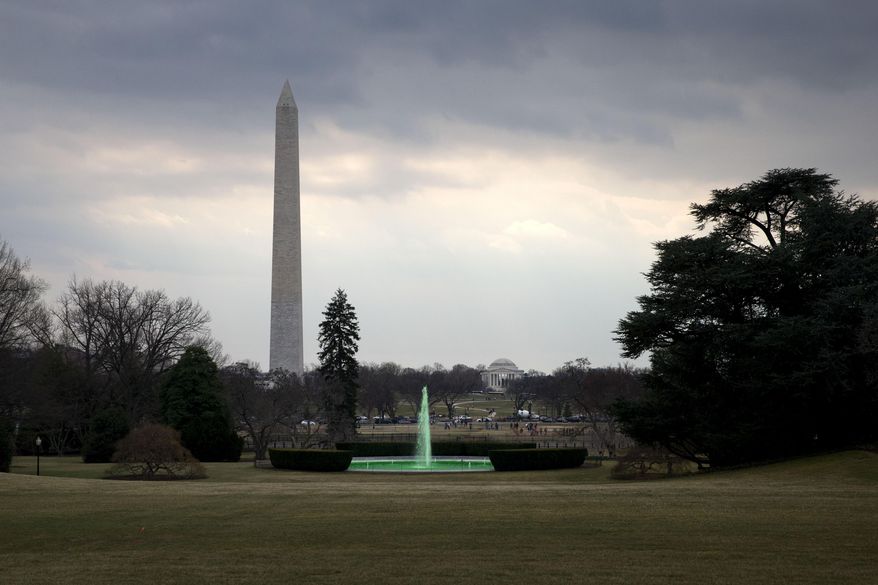 With the Washington Monument and Jefferson Memorial in the background, the fountain on the South Lawn of the White House in Washington, is dyed green for St. Patrick's Day, Tuesday, March 17, 2015, prior to President Barack Obama's motorcade taking the president to Capitol Hill for a "Friends of Ireland" luncheon. (AP Photo/Jacquelyn Martin)