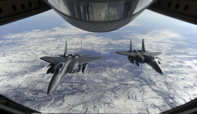 Two F-15E Strike Eagles wait to receive fuel from a KC-135R Stratotanker Jan. 23, 2015, on their way to Nellis Air Force Base, Nev., in support of Red Flag 15-1. (U.S. Air Force photo by Airman 1st Class Aaron J. Jenne/Released) **FILE**