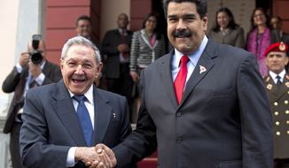 Cuba&#x27;s President Raul Castro, left, shakes hands with Venezuela&#x27;s President Nicolas Maduro in front of the press after arriving to Miraflores presidential palace for an emergency ALBA meeting in Caracas, Venezuela, Tuesday, March 17, 2015. The Venezuelan-led ALBA bloc of leftist regional governments is expected to express support for Venezuela&#x27;s position that its sovereignty is being violated by U.S. attempts to destabilize the country. (AP Photo/Ariana Cubillos)