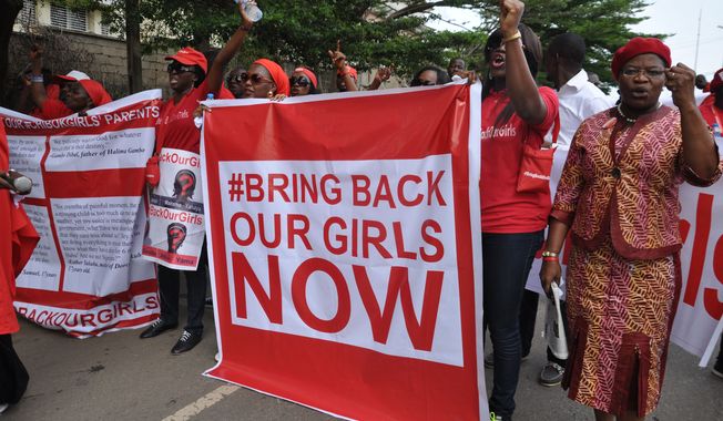 FILE - In this Tuesday Oct. 14, 2014 file photo, people demonstrate calling on the Nigerian government to rescue girls taken from a secondary school in Chibok region, in the city of Abuja, Nigeria. Nigeria&amp;#8217;s military says it has no news of the more than 200 schoolgirls kidnapped by Islamic extremists nearly a year ago, despite liberating dozens of towns from the girls&amp;#8217; Boko Haram abductors. (AP Photo/Olamikan Gbemiga, File)