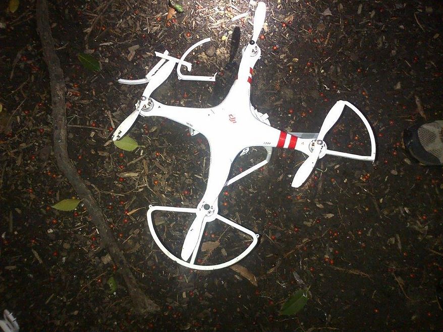 This handout photo provided by the US Secret Service shows the drone that crashed onto the White House grounds in Washington, Monday, Jan. 26, 2015. An intelligence agency employee whose drone crashed on the White House lawn earlier this year won't face criminal charges, the U.S. Attorney’s Office in Washington announced Wednesday. Shawn Usman, who works for the National Geospatial-Intelligence Agency, was piloting the borrowed drone in downtown Washington early on Jan. 26 when he lost control of it. Prosecutors said Usman, who had borrowed the drone from a friend, tried to regain control of the aircraft while it was flying westward and climbed to about 100 feet at about 3 a.m. (AP Photo/US Secret Service)