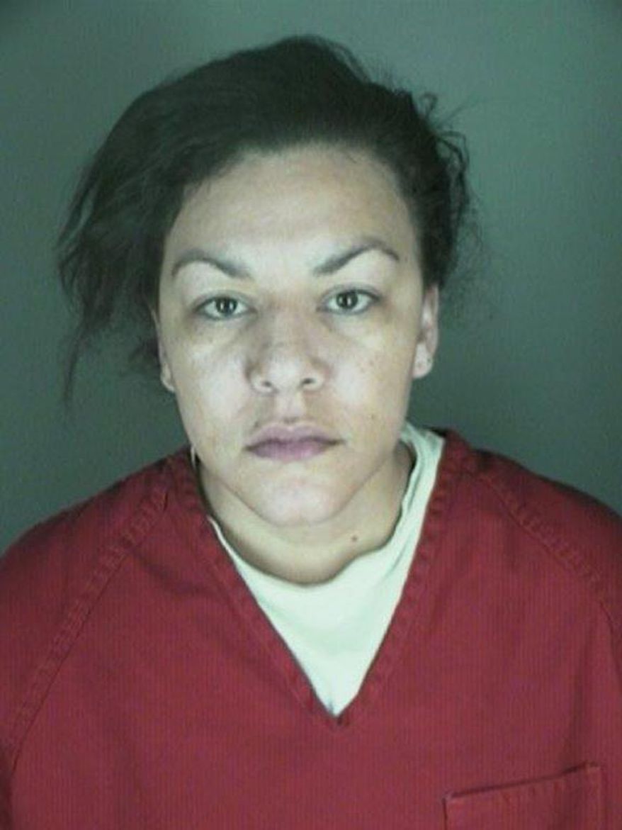 This undated booking photo provided by the Longmont Police Department shows Dynel Lyne, 34, who is accused of stabbing a pregnant woman in the stomach and removing her baby, while the expectant mother visited her home to buy baby clothes advertised on Craigslist authorities said. (AP Photo/ Longmont Police Department)