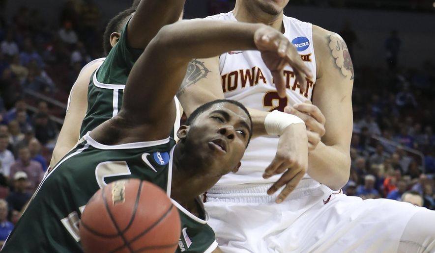 UAB guard Tyler Madison and Iowa State forward Abdel Nader grapple with a rebound before it went out of bounds during the second half of an NCAA tournament second round college basketball game in Louisville, Ky., Thursday, March 19, 2015. UAB won the game 60-59. (AP Photo/David Stephenson)