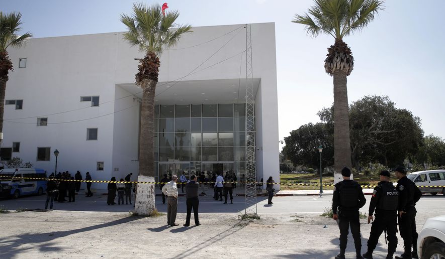 Policemen guard the entrance of the Bardo museum in Tunis, Tunisia, Thursday, March 19, 2015,  a day after gunmen opened fire killing over 20 people, mainly tourists. One of the two gunmen who killed  tourists and others at a prominent Tunisian museum was known to intelligence services, Tunisia&#39;s prime minister said Thursday. But no formal links to a particular terrorist group have been established in an attack that threatens the country&#39;s fledgling democracy and struggling tourism industry. (AP Photo/Christophe Ena)