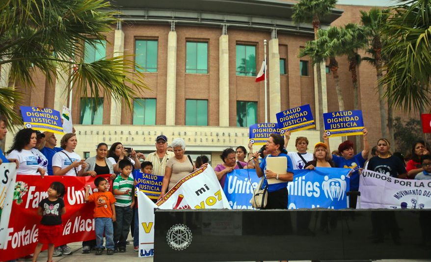 Various human rights organizations gathered outside the federal courthouse in Brownsville, Texas, Thursday, March 19, 2015. The Justice Department might face sanctions if a federal judge determines its attorneys misled him about whether part of President Barack Obama's executive action on immigration was implemented prior to it being put on hold by the judge. U.S. District Judge Andrew Hanen last month halted Obama's plan. The president's plan would spare from deportation up to 5 million people in the U.S. illegally. (AP Photo/The Brownsville Herald, Yvette Vela)