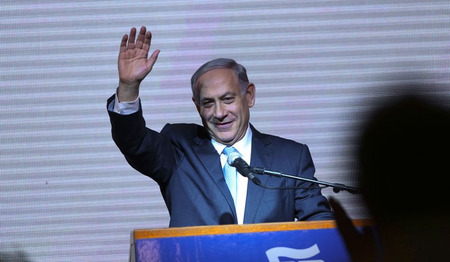 Israeli Prime Minister Benjamin Netanyahu greets supporters at the party&#39;s election headquarters in Tel Aviv on March 18, 2015. (Associated Press) **FILE**