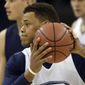 Virginia&#x27;s Justin Anderson runs a drill with his injured finger taped during practice at the NCAA college basketball tournament in Charlotte, N.C., Thursday, March 19, 2015.  Virginia plays Belmont in the second round on Friday. (AP Photo/Gerald Herbert)