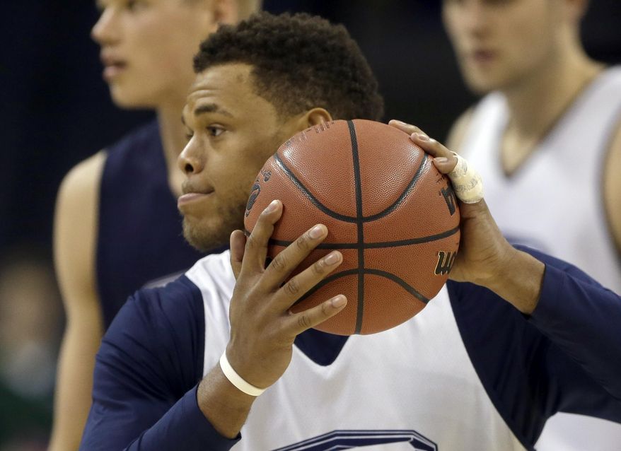 Virginia's Justin Anderson runs a drill with his injured finger taped during practice at the NCAA college basketball tournament in Charlotte, N.C., Thursday, March 19, 2015.  Virginia plays Belmont in the second round on Friday. (AP Photo/Gerald Herbert)