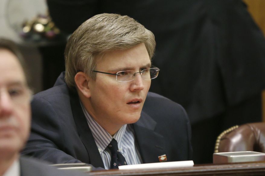 Rep. Justin Harris, R-West Fork, listens to discussion on a bill that prohibits re-homing of an adopted child in the House chamber at the Arkansas state Capitol in Little Rock, Ark., Friday, March 20, 2015. (AP Photo/Danny Johnston)