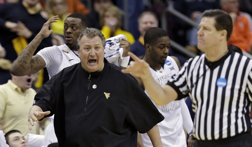 West Virginia head coach Bob Huggins argues a call in the first half of an NCAA tournament college basketball game against Buffalo in the Round of 64 in Columbus, Ohio Friday, March 20, 2015. (AP Photo/Tony Dejak)