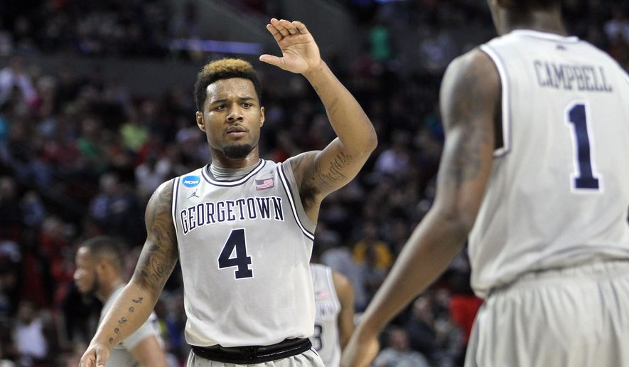 Georgetown guard D&#39;Vauntes Smith-Rivera, left, high-fives teammate Tre Campbell during the second half of an NCAA college basketball second round game against Eastern Washington in Portland, Ore., Thursday, March 19, 2015. (AP Photo/Craig Mitchelldyer)