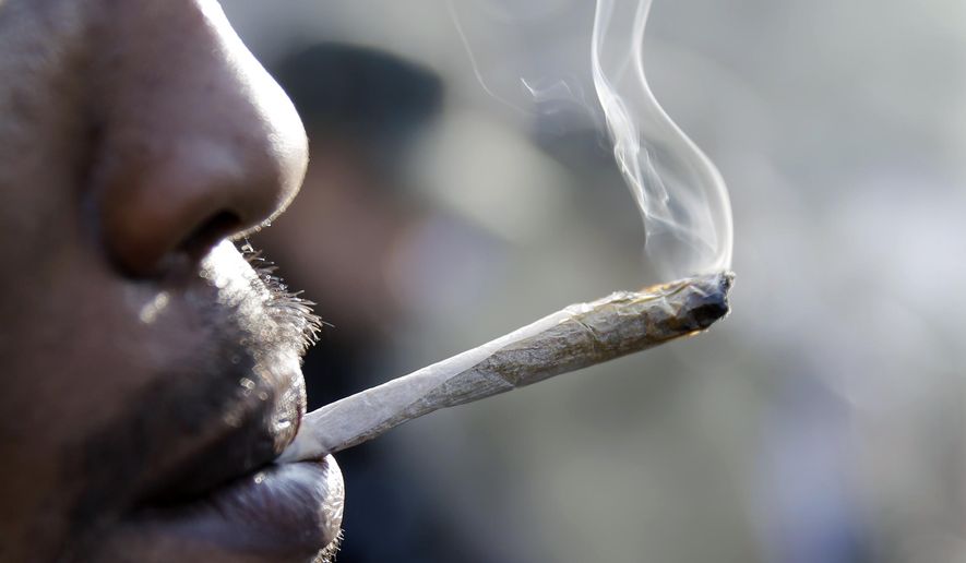 A man smokes a marijuana cigarette as a large group gathered near the New Jersey Statehouse to show their support for legalizing marijuana Saturday, March 21, 2015, in Trenton, N.J. The event drew a diverse crowd of roughly 200 people. Many said they wanted to show their support for legalizing or decriminalizing pot, while others said it should only be given to people with medical conditions that could be eased by the drug. Several people were openly smoking the drug during Saturday&#x27;s rally, but apparently none were arrested. (AP Photo/Mel Evans)