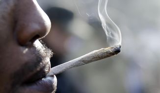 A man smokes a marijuana cigarette as a large group gathered near the New Jersey Statehouse to show their support for legalizing marijuana Saturday, March 21, 2015, in Trenton, N.J. The event drew a diverse crowd of roughly 200 people. Many said they wanted to show their support for legalizing or decriminalizing pot, while others said it should only be given to people with medical conditions that could be eased by the drug. Several people were openly smoking the drug during Saturday&#39;s rally, but apparently none were arrested. (AP Photo/Mel Evans)