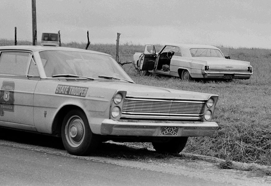 In this March 26, 1965 file photo, an Alabama state troopers car is parked on the side of the road near Lownsboro, Ala, where Viola Gregg Liuzzo of Detroit, was shot to death while enroute to Montgomery. Wayne State University plans to give an honorary doctor of laws degree to Liuzzo during a ceremony on April 10. It will be the first posthumous honorary degree in the school’s history. (AP Photo/Jack Thornell, File)