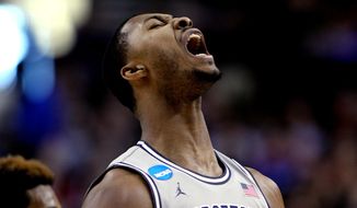 Georgetown forward Mikael Hopkins reacts during the first half of an NCAA college basketball tournament round of 32 game against Utah in Portland, Ore., Saturday, March 21, 2015. (AP Photo/Craig Mitchelldyer)