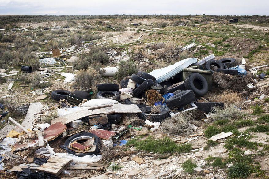 This March 17, 2015 photo shows trash that people have dumped illegally at the Hub Butte Bureau of Land Management site south of Twin Falls, Idaho. Hub Butte is open sagebrush land littered with old tires, shattered televisions, ripped mattresses and rotting animal carcasses. Now, the Twin Falls County Sheriff's Office, Idaho Department of Fish and Game and the Twin Falls District BLM are asking recreationists to keep their eye out for people illegally dumping trash on public land. Of the 60 known dumping sites within BLM's Twin Falls District, this area is considered the worst. It will cost an estimated $30,000 to clean up. (AP Photo/The Times-News, Stephen Reiss)