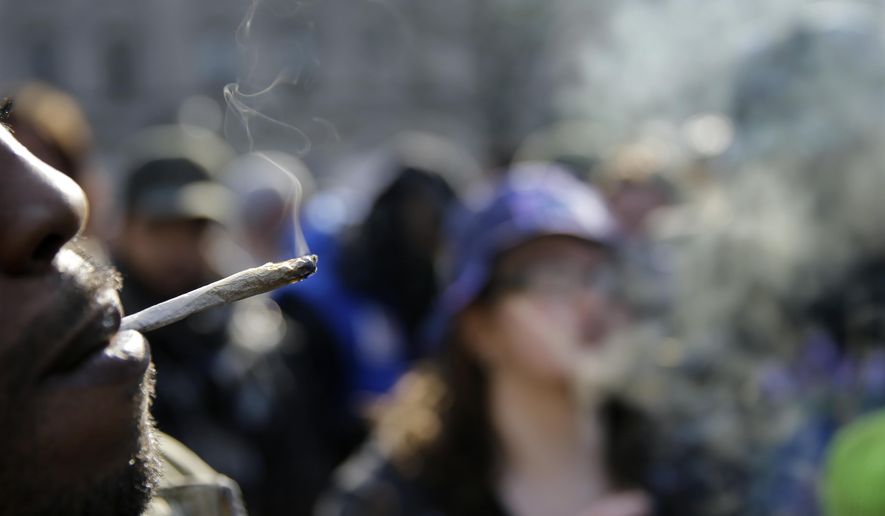 People smoke marijuana cigarettes as a large group gathered near the New Jersey Statehouse to show their support for legalizing marijuana Saturday, March 21, 2015, in Trenton, N.J. (AP Photo/Mel Evans)