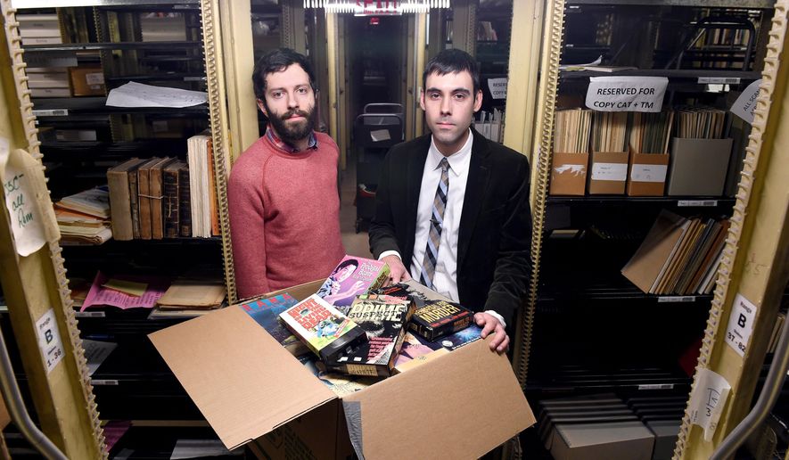 ADVANCE FOR SATURDAY, MARCH 21, 2015 - In this Wednesday, March 11, 2015 photo Yale PhD student Aaron Pratt, left, and David Gary, Kaplanoff Librarian for American History, are photographed in the basement of Sterling Memorial Library with part of a collection of horror and exploitation VHS films recently acquired by Yale University in New Haven, Conn. (AP Photo/New Haven Register, Arnold Gold)