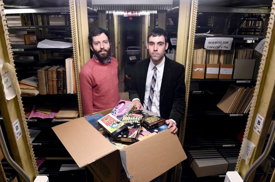 ADVANCE FOR SATURDAY, MARCH 21, 2015 - In this Wednesday, March 11, 2015 photo Yale PhD student Aaron Pratt, left, and David Gary, Kaplanoff Librarian for American History, are photographed in the basement of Sterling Memorial Library with part of a collection of horror and exploitation VHS films recently acquired by Yale University in New Haven, Conn. (AP Photo/New Haven Register, Arnold Gold)