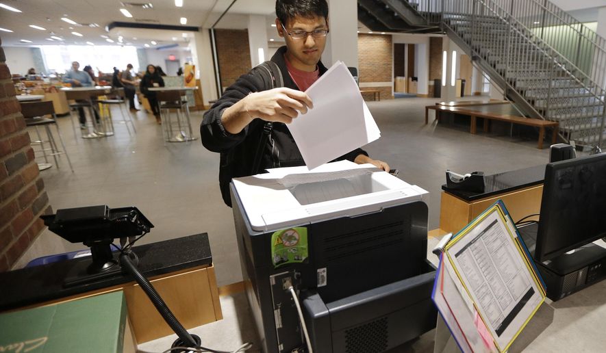 In this Feb. 24, 2015 photo, Vivek Shah, a sophomore resident advisor at Vanderbilt University&#39;s Moore College, uses the computer printer in the lobby of the student housing complex in Nashville, Tenn. (AP Photo/Mark Humphrey) **FILE**