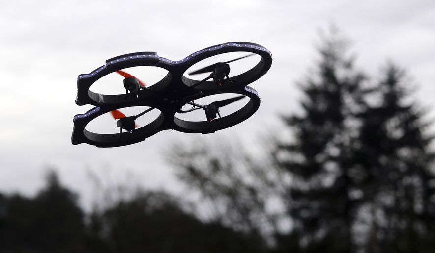 A radio-controlled drone appears in flight during an International Drone Day event at an elementary school in Roseburg, Ore., in this March 14, 2015, file photo. (AP Photos/The News-Review, Michael Sullivan, File)