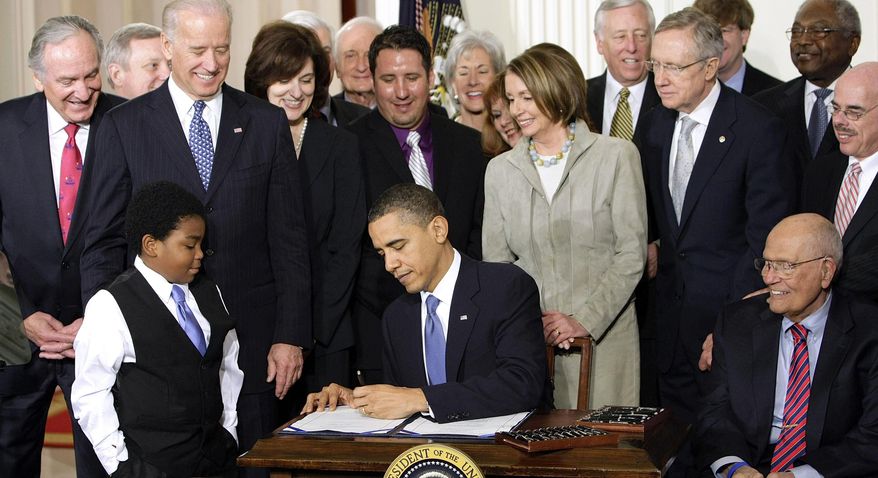 FILE - In this March 23, 2010. file photo, President Barack Obama signs the health care bill in the East Room of the White House in Washington. When President Barack Obama signed the Affordable Care Act five years ago, he visualized a time when the political hyperbole would be silenced and ordinary people would see that the health care law improved their lives. The White House signing ceremony on Mar. 23, 2010 was an applause-filled celebration. “When I sign this bill,” Obama said, “all of the overheated rhetoric over reform will finally confront the reality of reform.” (AP Photo/J. Scott Applewhite, File)