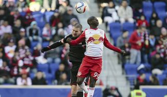 D.C. United defender Bobby Boswell, left, and New York Bulls&#39; Bradley Wright-Phillips (99) vie for a header during the first half of an MLS soccer game, Sunday, March 22, 2015, in Harrison, N.J. (AP Photo/John Minchillo)
