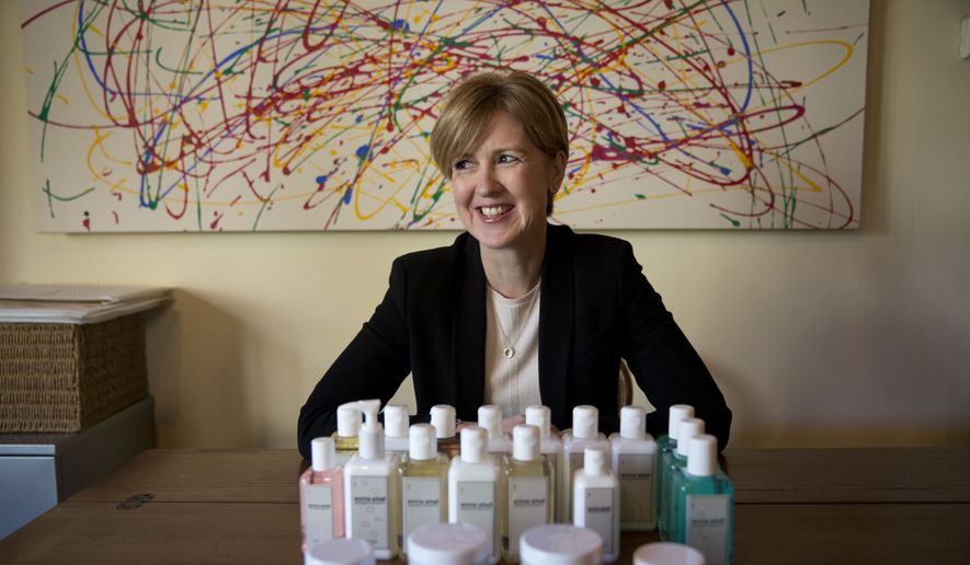 In this photo taken Friday, Jan. 30, 2015, aromatherapist Emma Arkell poses for a portrait with one of the natural remedies for the skin and body she makes near Winchester, England. Evidence is growing that gender equity is not just politically correct window-dressing, but good business. (AP Photo/Matt Dunham)