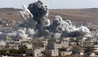 In this Oct. 22, 2014, file photo, thick smoke from an airstrike by the U.S.-led coalition rises in Kobani, Syria, as seen from a hilltop on the outskirts of Suruc, at the Turkey-Syria border. (AP Photo/Lefteris Pitarakis, File)