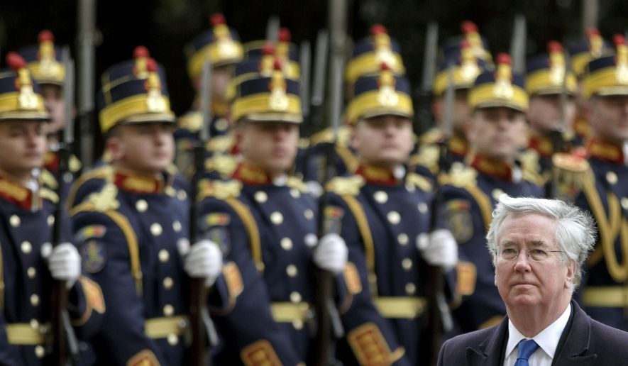 Britain's Defense Secretary Michael Fallon reviews an honor guard in Bucharest, Romania, Monday, March 23, 2015. Fallon said NATO members Romania and Britain will not be intimidated by threats against members of the military alliance, referring to Russia's ambassador to Denmark, Mikhail Vanin's remarks this weekend that Danish warships could become targets for Russian nuclear missiles if the Danes join the alliance's missile defense system.(AP Photo/Vadim Ghirda)