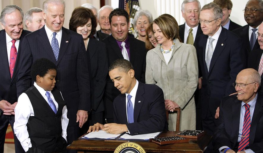 FILE - In this March 23, 2010, file photo, President Barack Obama signs the health care bill in the East Room of the White House in Washington. A couple of government reports say the number of uninsured U.S. residents fell by more than 11 million since Obama signed the health care overhaul five years ago. (AP Photo/J. Scott Applewhite, File)