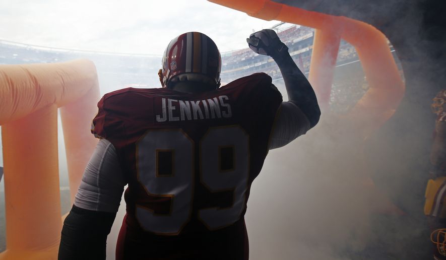 Washington Redskins defensive end Jarvis Jenkins (99) reacts to his introduction from the tunnel during the first half of an NFL football game against the Dallas Cowboys in Landover, Md., Sunday, Dec. 28, 2014. (AP Photo/Alex Brandon)