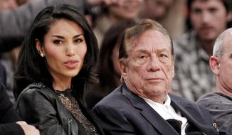 Los Angeles Clippers owner Donald Sterling, right, sits with V. Stiviano as they watch the Clippers play the Los Angeles Lakers during an NBA preseason basketball game in Los Angeles in this Dec. 19, 2011, file photo. Sterling&#x27;s wife, Shelly Sterling, is going after the $2.5 million in real estate and cars her husband lavished on V. Stiviano in a trial scheduled to begin Wednesday, March 25, 2015, in Los Angeles Superior Court. (AP Photo/Danny Moloshok, File)