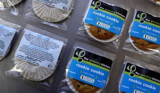 In this Sept. 26, 2014, file photo, smaller-dose pot-infused cookies, called the Rookie Cookie, sit on the packaging table at The Growing Kitchen, in Boulder, Colo. (AP Photo/Brennan Linsley, File)