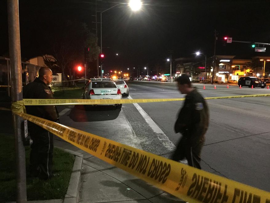 Law enforcement officers have an area blocked off as they search for a suspect in the fatal shooting of a San Jose, Calif., police officer Tuesday, March 24, 2015. Authorities say the officer was shot to death after responding to a call about a man threatening to kill himself. The San Jose Police Department says responding officers were met with gunfire Tuesday night. A veteran officer was struck and pronounced dead at the scene. (AP Photo/San Jose Mercury News, Josie Lepe)