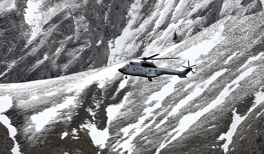 A French army helicopter heads to the Germanwings flight crash site near Seyne-les-Alpes, Wednesday, March 25, 2015, after the jetliner crashed Tuesday in the French Alps. (Associated Press)