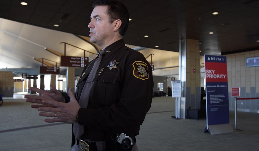 Saginaw County Sheriff William Federspiel speaks with reporters at MBS International Airport in Freeland, Mich., Tuesday, March 24, 2015. Federspiel announced plans to increase his office's presence at the airport following an attack by a machete-wielding man at an airport in Louisiana. The sheriff's department has a contract with the airport to provide security. He says the law enforcement presence serves as a deterrent. (AP Photo/The Saginaw News, David C Bristow ) ALL LOCAL TELEVISION OUT; LOCAL TELEVISION INTERNET OUT