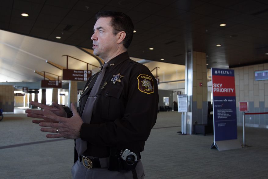 Saginaw County Sheriff William Federspiel speaks with reporters at MBS International Airport in Freeland, Mich., Tuesday, March 24, 2015. Federspiel announced plans to increase his office's presence at the airport following an attack by a machete-wielding man at an airport in Louisiana. The sheriff's department has a contract with the airport to provide security. He says the law enforcement presence serves as a deterrent. (AP Photo/The Saginaw News, David C Bristow ) ALL LOCAL TELEVISION OUT; LOCAL TELEVISION INTERNET OUT