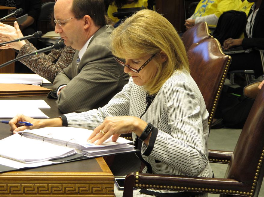 Health and Hospitals Secretary Kathy Kliebert reviews notes and financial documents before making her budget presentation to the House Appropriations Committee, Wednesday, March 25, 2015, in Baton Rouge, La. Lawmakers on the committee expressed concerns about possible cuts to health services for next year. (AP Photo/Melinda Deslatte)