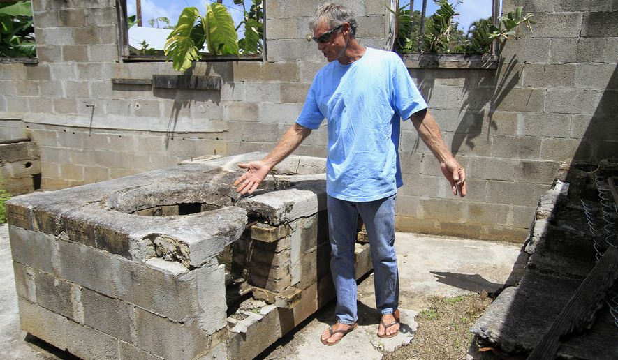ADVANCE FOR SATURDAY MARCH 28 AND THEREAFTER This March 21, 2015 photo shows property owner Randall Brokaw as he looks at an old stove surface in a derelict kitchen structure at the site of the former Chee Kung Tong Society building in Wailuku, Hawaii. Brokaw knows the clock is ticking for a possibly century-old Chinese wall, with ties to the venerable Dr. Sun Yat-sen, before it is destroyed or crumbles away in old Wailuku town. (AP Photo/The Maui News, Chris Sugidono)